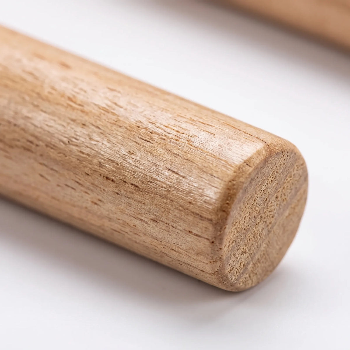 Close-up of the rounded end of a natural wooden perch, showing the pale grain and rough end surface. 3
