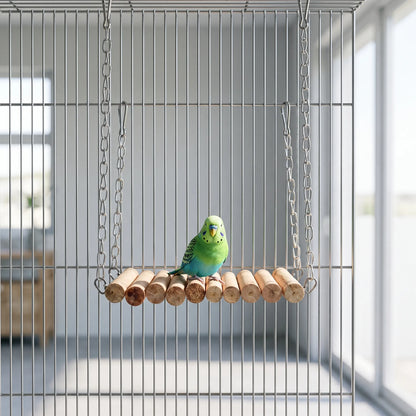 Green and blue budgerigar perched on the wooden rung bridge, which hangs by chains inside a wire cage. 2
