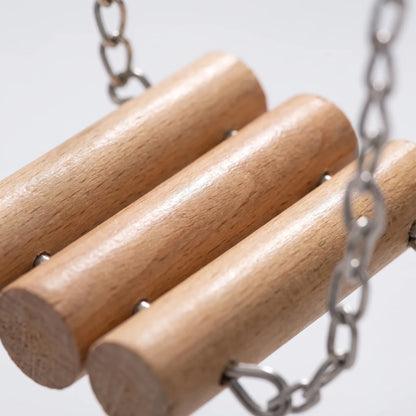 Close-up of three smooth round wooden rungs joined by metal pins and linked to steel chains. 3