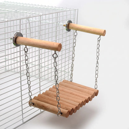 Plain wooden rung bridge hanging by chains from two bolted wooden perches on a white wire cage. 5