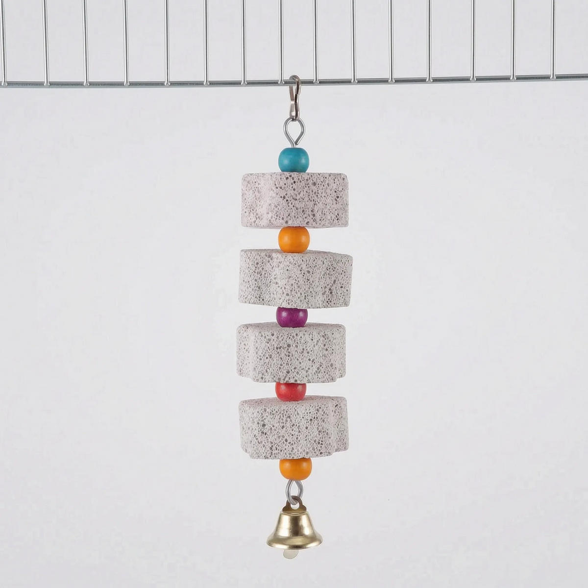 Four pumice blocks alternating with turquoise, orange, purple, red and orange beads, ending in a brass bell, hung from a cage wire. 8