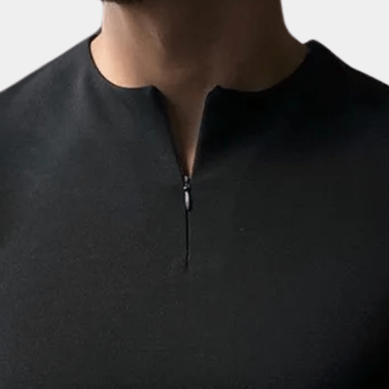 Close-up of the neckline on a model, showing the metal zip pull on a black top 6