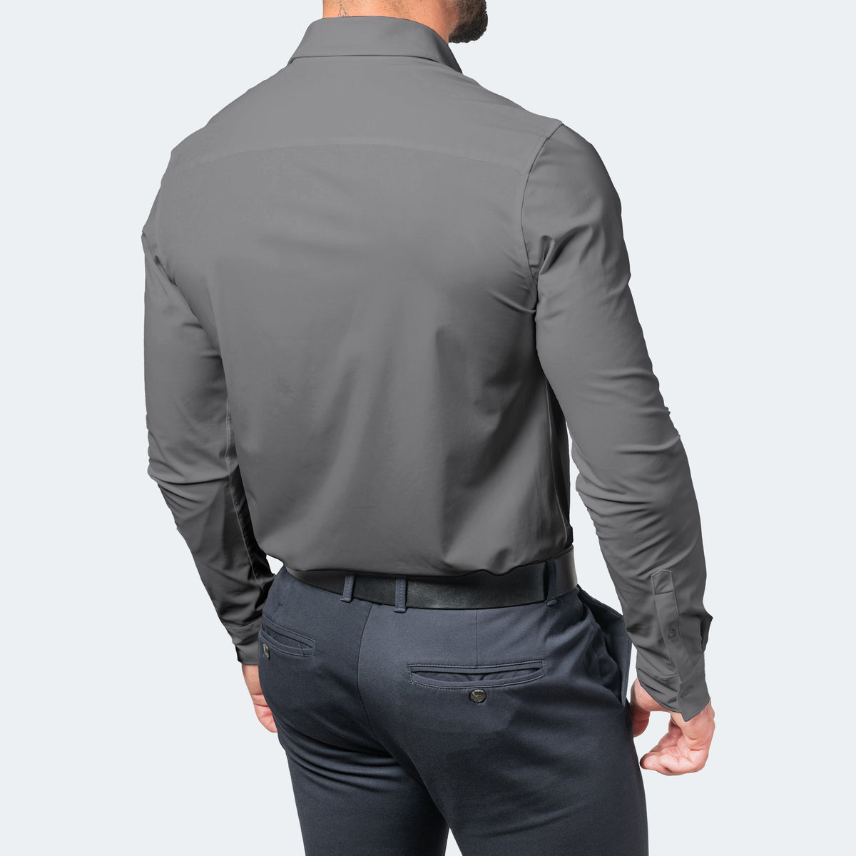 Back view of a grey shirt on a model, showing the smooth back panel and collar 9