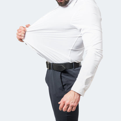 Side view of a man in a white shirt pulling the stretchy fabric away from his chest 1