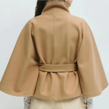 Closer back view of the camel cape jacket, showing the centre seam and gathered belted waist 9