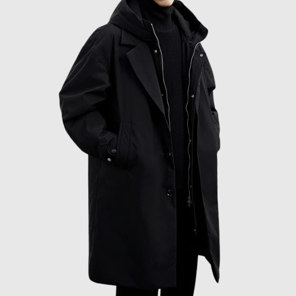 Cropped front view of the black hooded raincoat worn with the zip open over a black jumper 4