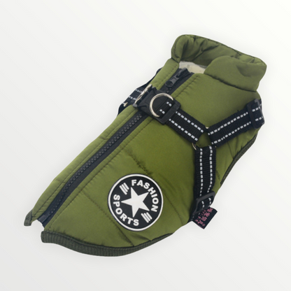 Green quilted jacket laid flat with ribbed olive trim, padded collar, zip, round patch and black reflective harness straps. 18