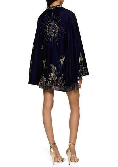Back view of the dress under the navy velvet cape, which has a large gold sun and fairy embroidery 10