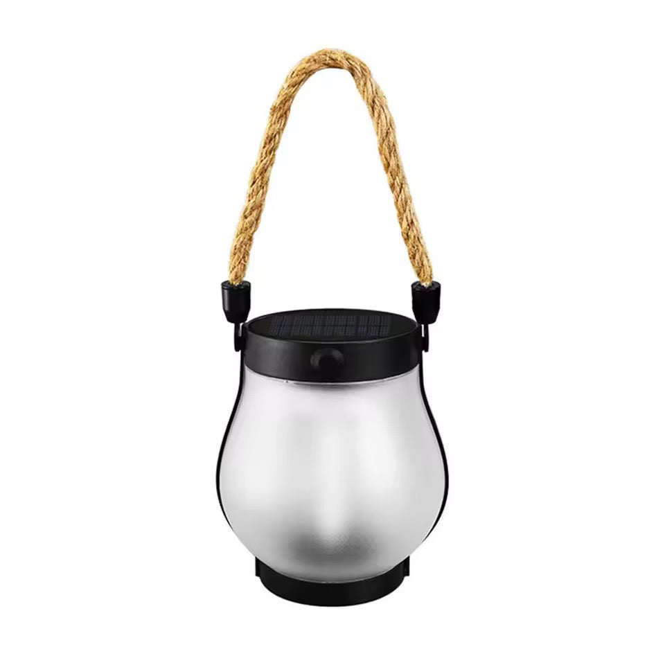 Unlit lantern on a white background showing the frosted glass, black solar top and rope handle 6