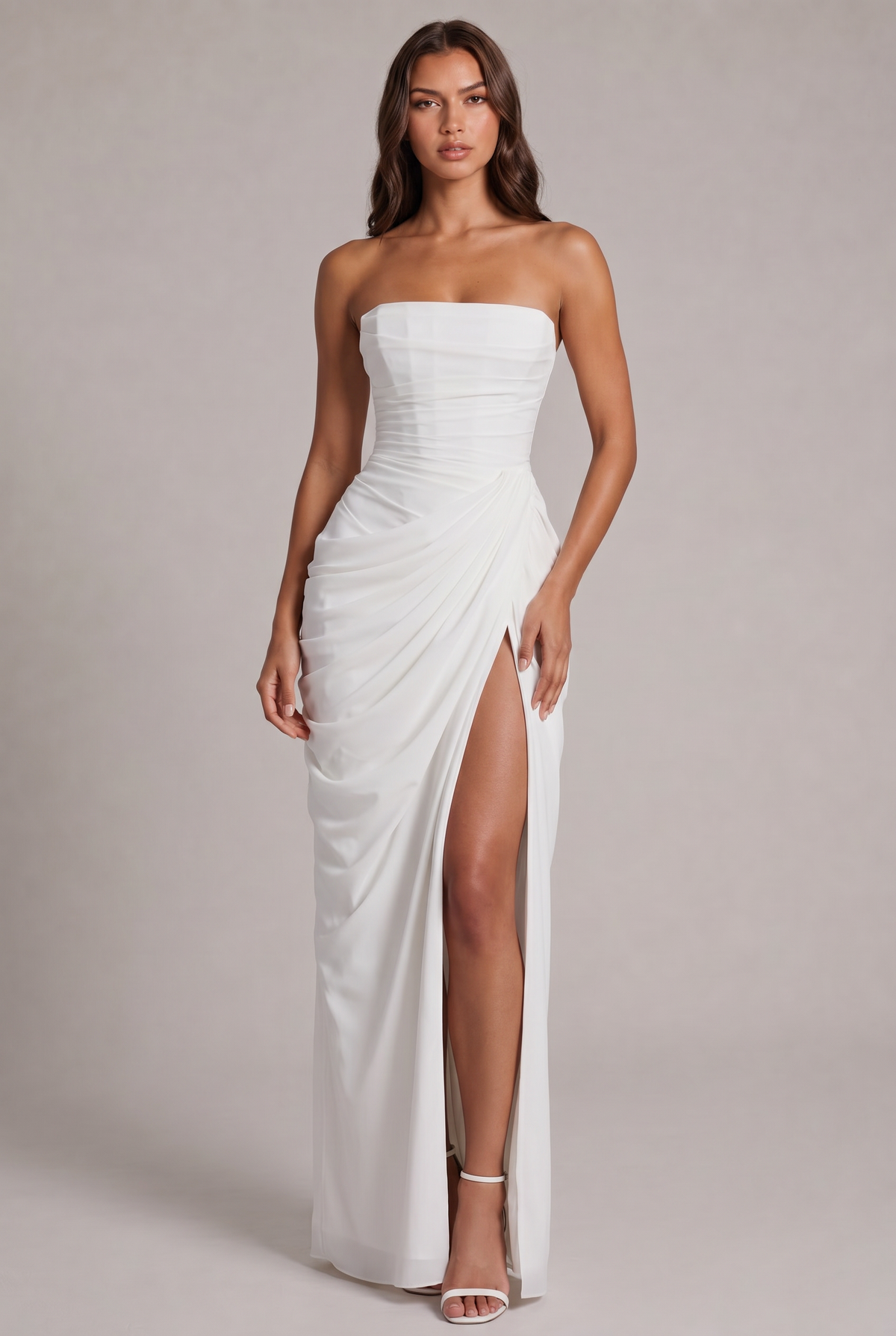 Front view of the white strapless maxi dress with draped skirt and thigh-high slit 17