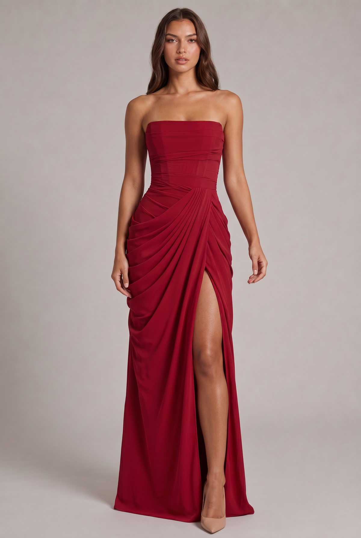 Model facing forward in the red strapless maxi dress, with draped skirt and high leg slit 21