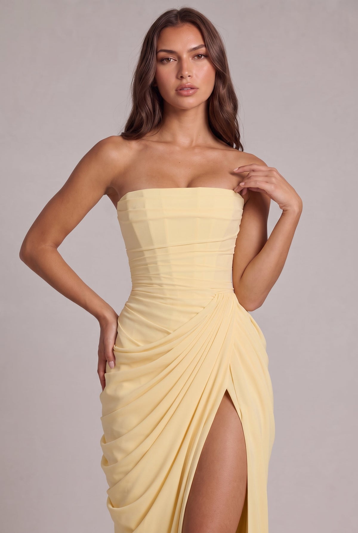 Close-up of the pale yellow corset bodice and gathered wrap drape at the waist 2