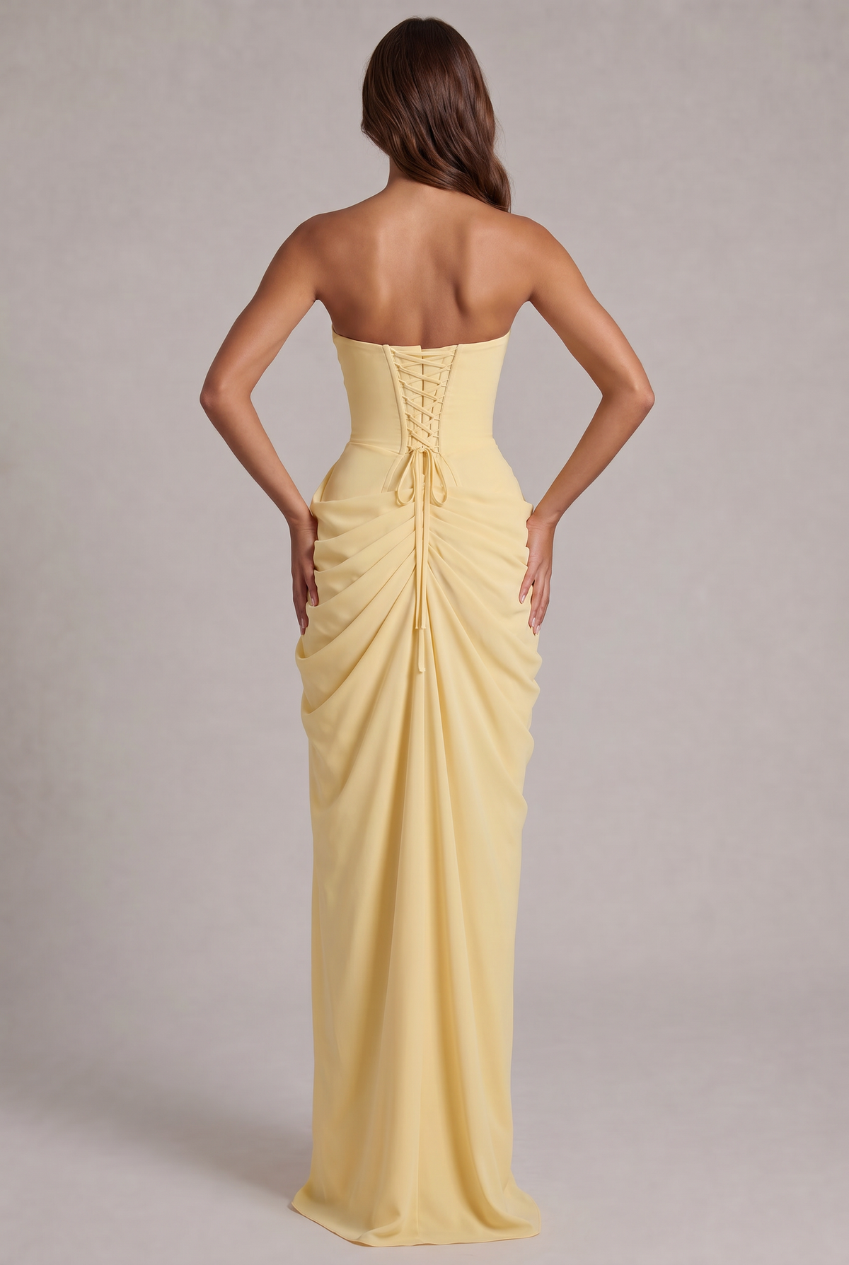 Back view of the pale yellow dress with lace-up corset back and ruched skirt 4