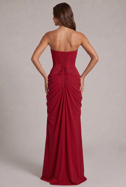 Back view of the red dress showing the lace-up corset back and ruched skirt 24