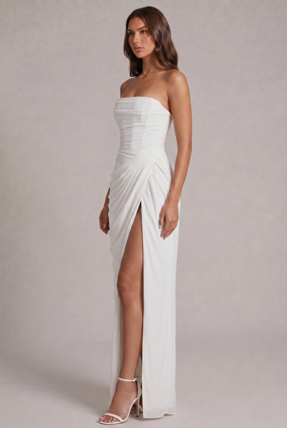 Angled side view of the white strapless dress with pleated wrap detail and slit 19