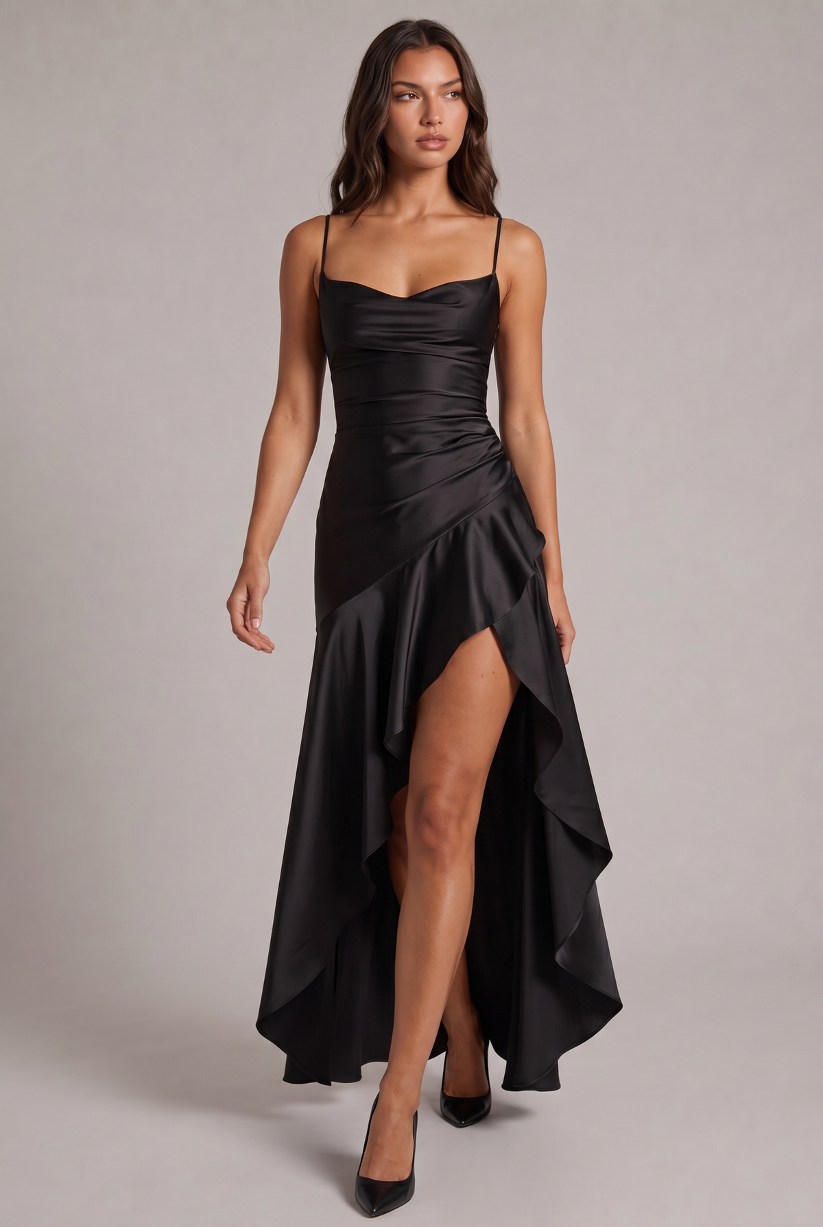 Black satin maxi dress on a model, full-length front view with ruffled slit, walking in black court shoes. 9