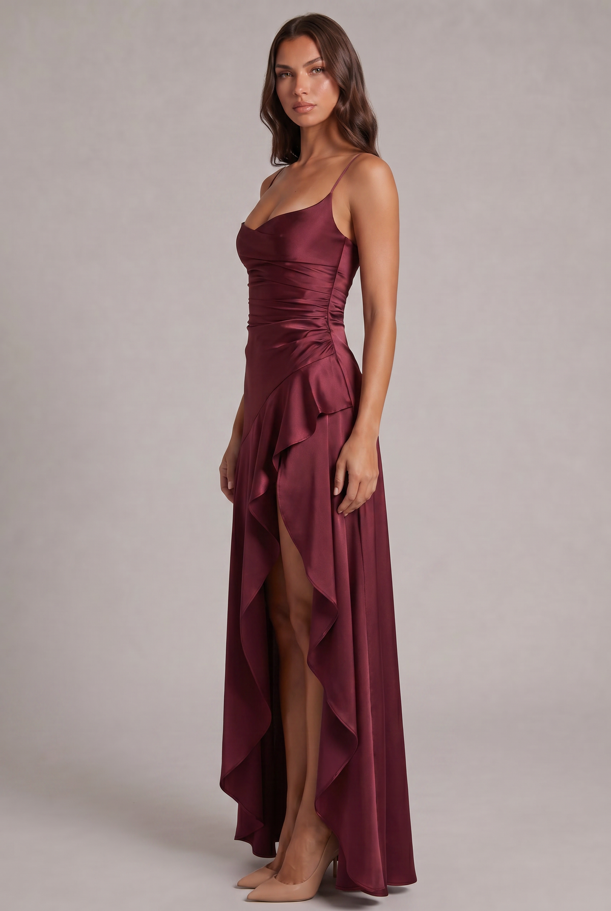 Side view of the burgundy satin dress, showing the ruched side seam, cascading ruffle and high front slit. 3