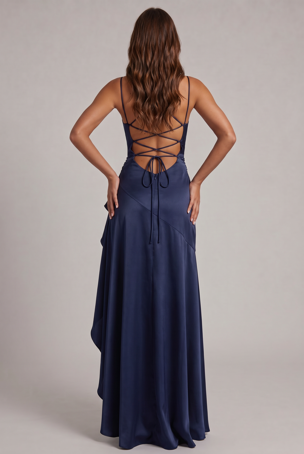 Back view of the navy dress showing the criss-cross lace-up open back, tie closure and flowing skirt. 8