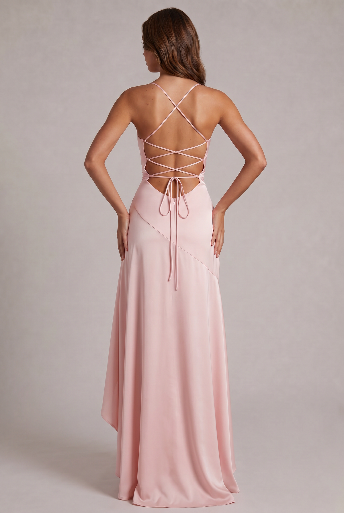 Back view of the pale pink dress showing the lace-up criss-cross open back, tie and flowing skirt. 20