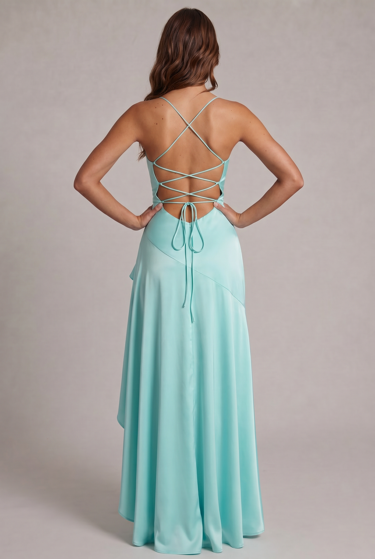 Back view of the aqua satin dress, showing the crisscross lace-up back, tie ends and flowing ruffled skirt. 24