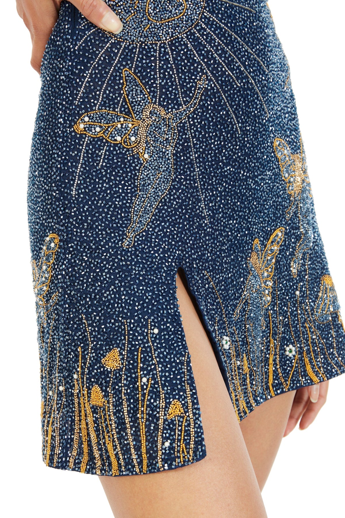 Close-up of the dense blue beadwork with gold fairy, mushroom and grass embroidery beside the thigh slit 4