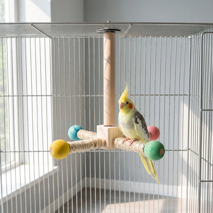 Perch hanging from the roof of a wire cage, with a yellow cockatiel standing on one of the sisal-wrapped arms. 2