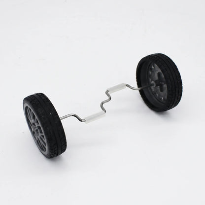 Pair of black rubber-tyred wheels joined by a bent metal axle with white grip sleeves, shown on a plain white background. 1