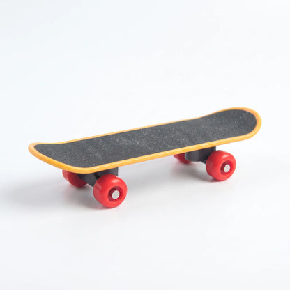 Miniature skateboard toy with a gritty black deck, yellow edging and red wheels, shown on a plain white background. 1