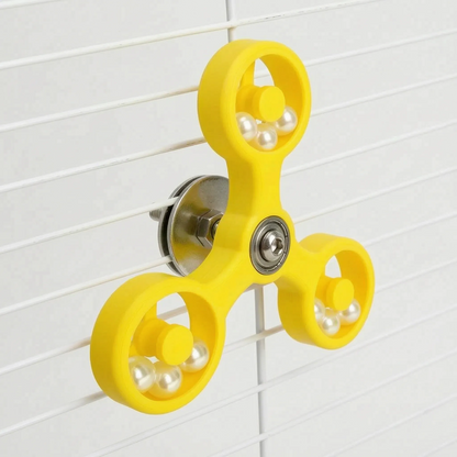Angled view of the yellow spinner clamped to white cage bars, showing the steel washer, nut and bolt holding it in place. 7