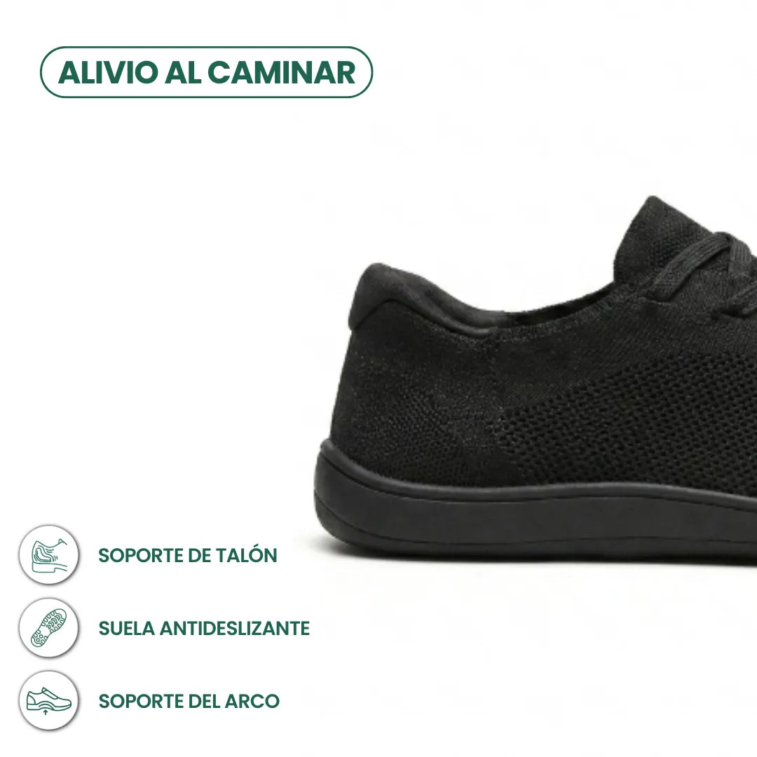 Close-up of the black trainer's heel and sole with icons for heel support, non-slip sole and arch support. 13