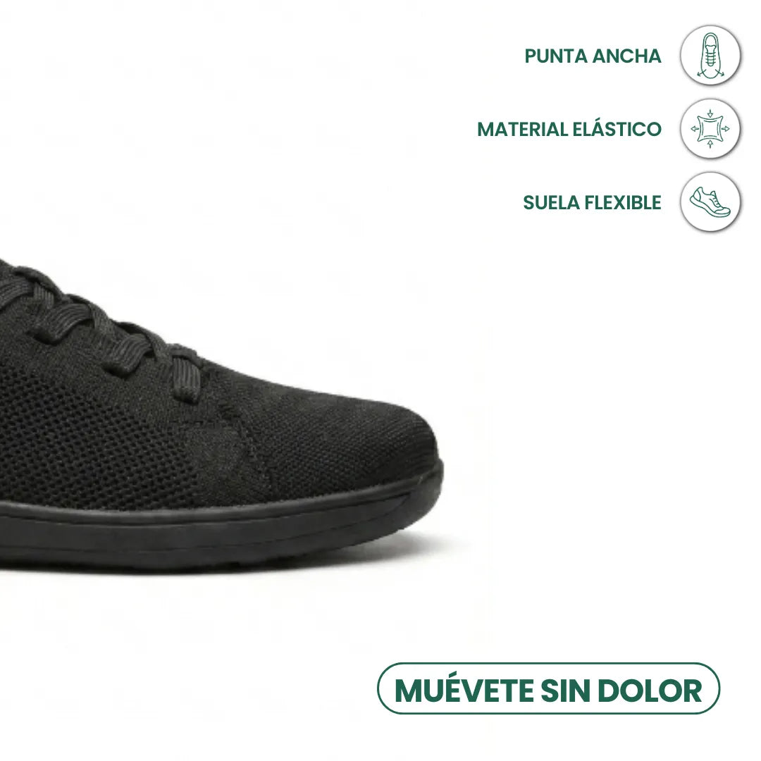 Close-up of the black trainer's wide toe area with icons for roomy toe, stretchy material and flexible sole. 14