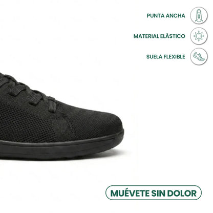 Close-up of the black trainer's wide toe area with icons for roomy toe, stretchy material and flexible sole. 14