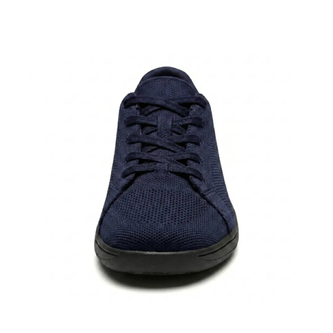 Front view of a navy mesh trainer with black sole, showing the rounded wide toe and laces. 26