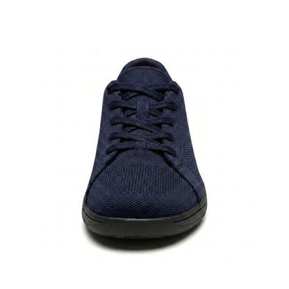 Front view of a navy mesh trainer with black sole, showing the rounded wide toe and laces. 26