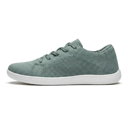 Side view of a single sage green mesh trainer with white sole and matching laces. 28