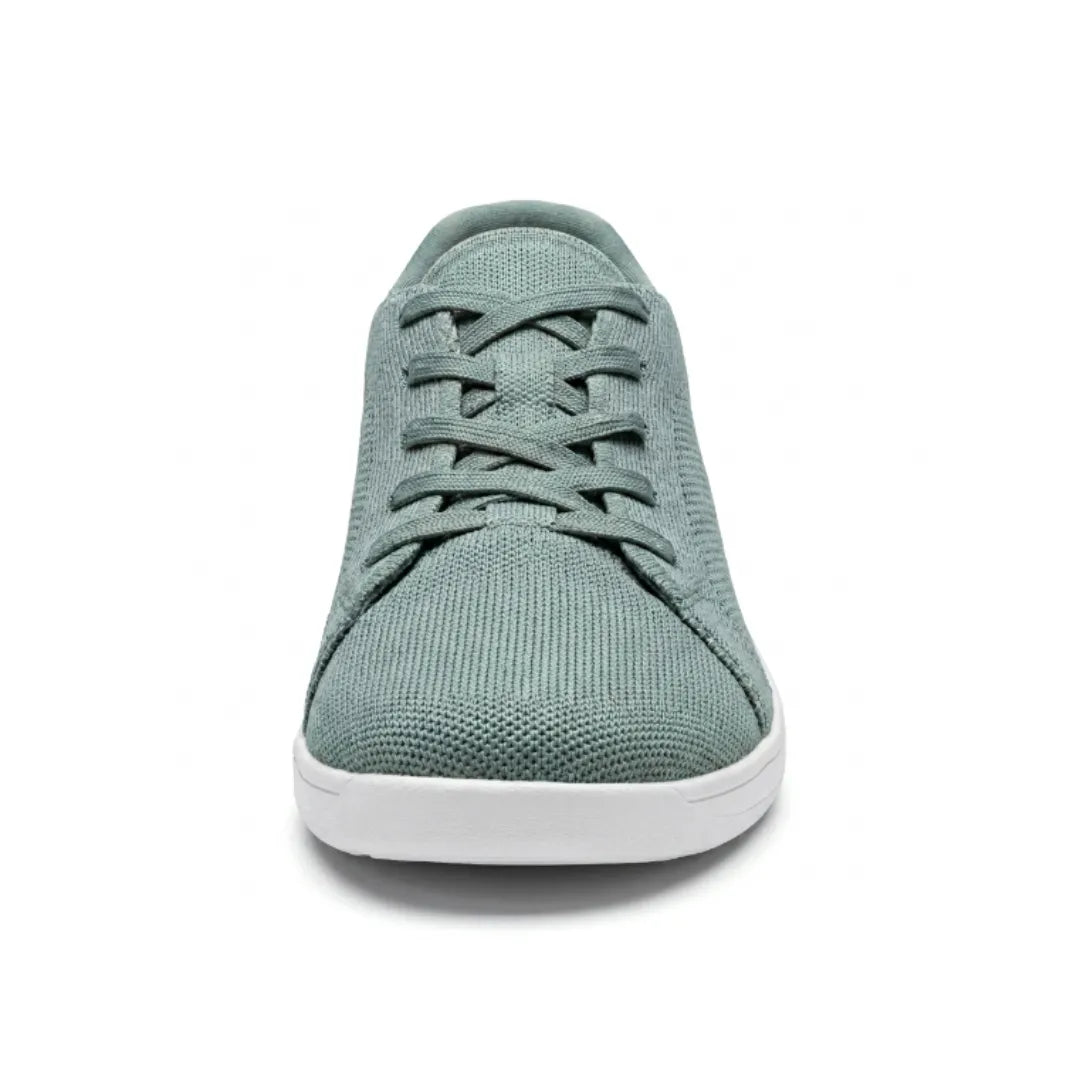 Front view of a sage green mesh trainer with white sole, showing the rounded wide toe and crossed laces. 35