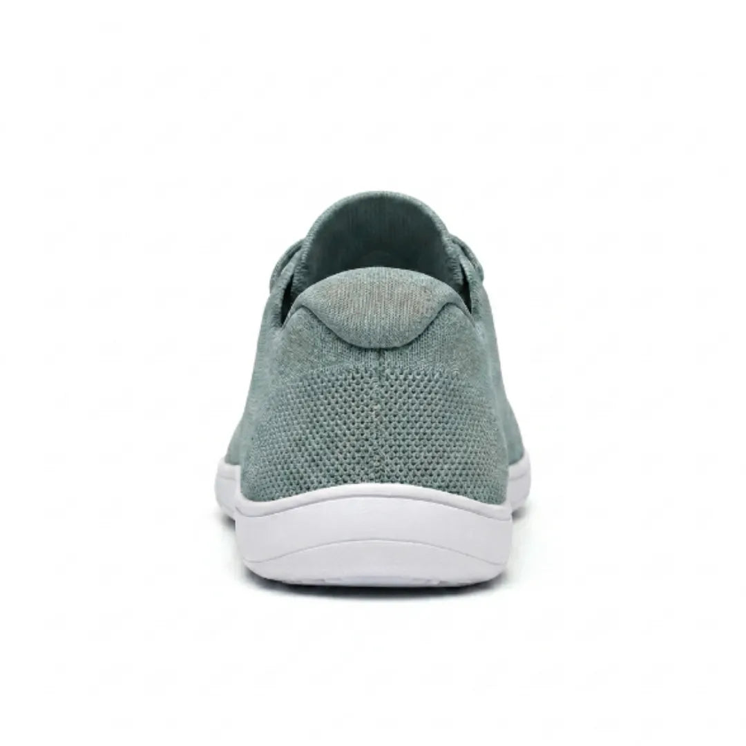 Rear view of a sage green mesh trainer with white sole, showing the heel tab and knitted heel panel. 36