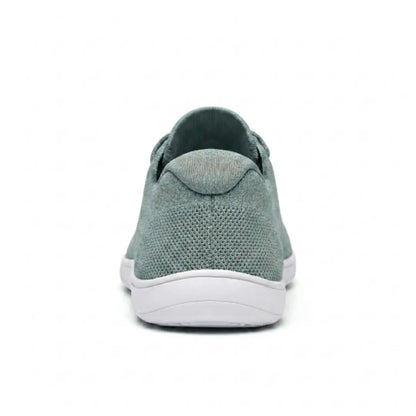 Rear view of a sage green mesh trainer with white sole, showing the heel tab and knitted heel panel. 36