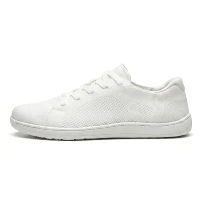 Side view of a single all-white mesh trainer with white sole and white laces. 37