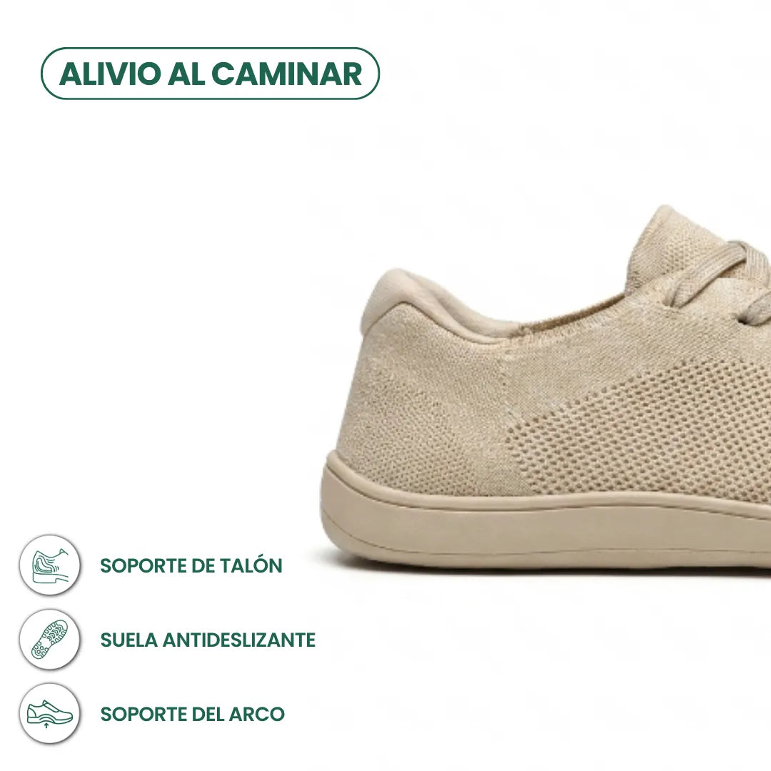 Close-up of the beige trainer's heel and sole with icons for heel support, non-slip sole and arch support. 4