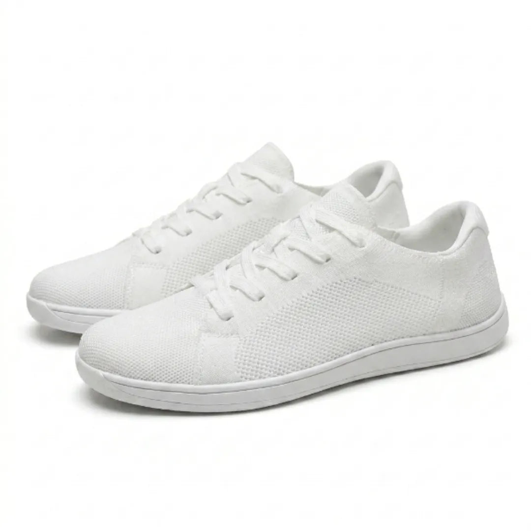 Pair of white lace-up knit trainers with flat white soles, shown at an angle against a plain light background. 43