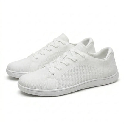 Pair of white lace-up knit trainers with flat white soles, shown at an angle against a plain light background. 43