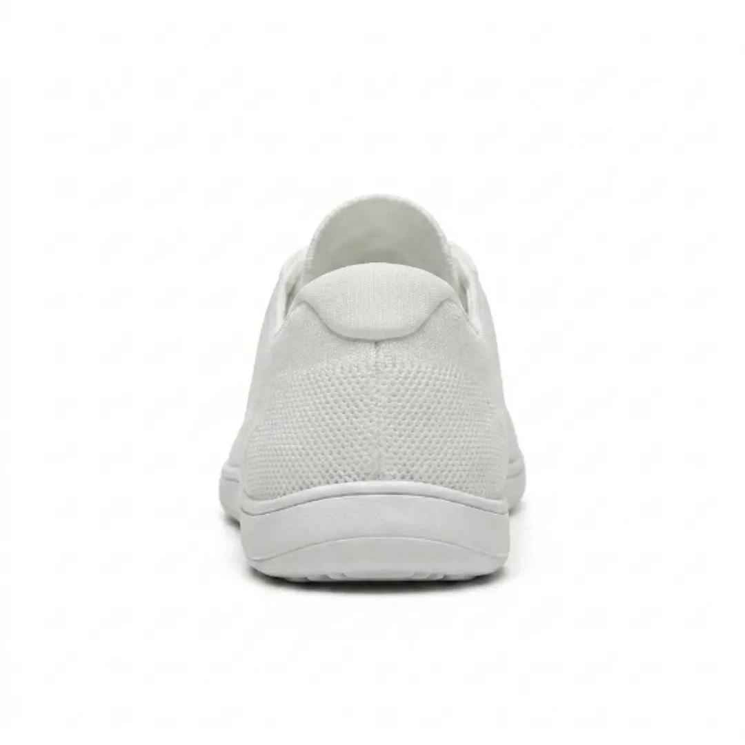 Rear view of a white knit trainer showing the heel tab, breathable mesh texture and flat white sole. 45