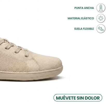 Close-up of the beige trainer's wide toe area with icons for roomy toe, stretchy material and flexible sole. 5