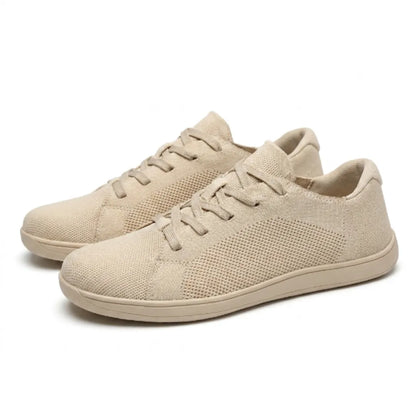 Pair of beige knit trainers angled together, showing laces, mesh side panels and flat soles. 7