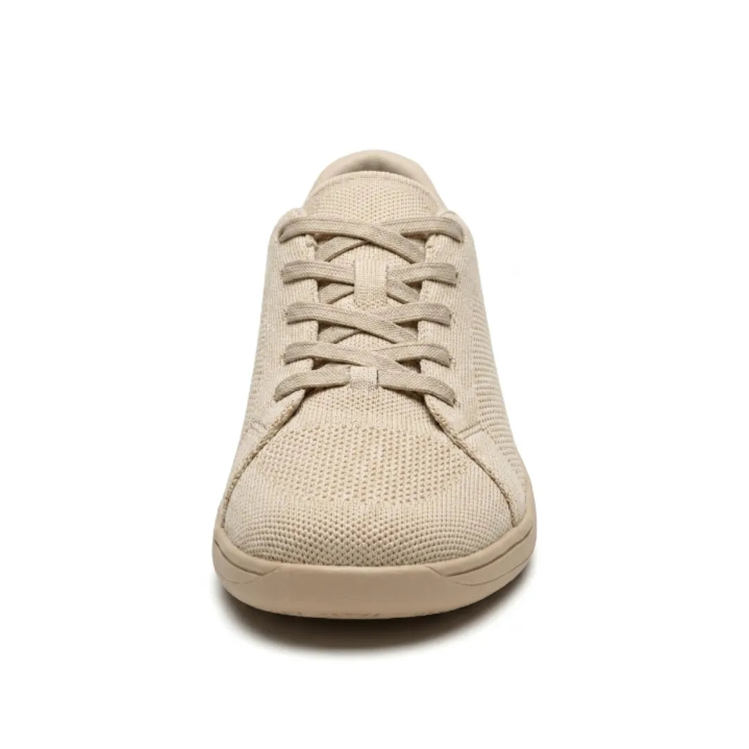 Front view of a beige knit trainer showing the criss-cross laces, rounded wide toe cap and flat sole. 8