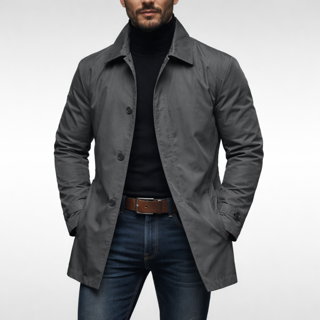 Studio front view of the grey button-front jacket worn open over a black roll-neck, jeans and a brown leather belt. 1
