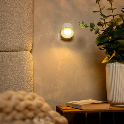 White lamp lit above a rustic wooden crate holding a book and a ribbed vase 7