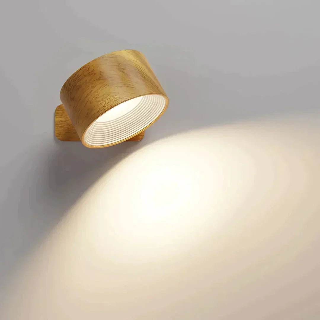 Wood-effect lamp head tilted down, spreading a soft pool of light on the wall 9