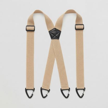 Flat lay of beige X-shape braces with four black clip hooks and a black centre patch 15